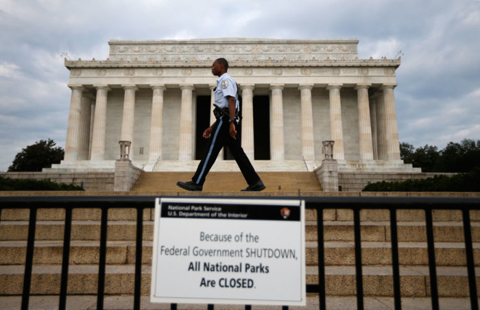 Credit : A National Parks policeman walks past a sign after the Lincoln Memorial was sealed off from visitors in Washington, October 1, 2013. The U.S. government began a partial shutdown on Tuesday for the first time in 17 years, potentially putting up to 1 millio