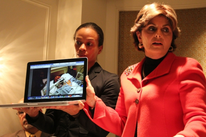 Celebrity lawyer Gloria Allred (r) and Dayana Mejia (l) longtime partner of injured biker Edwin Mieses Jr. hold up a laptop displaying photos of the biker in the hospital on at a press conference in Manhattan, N.Y. on Friday.