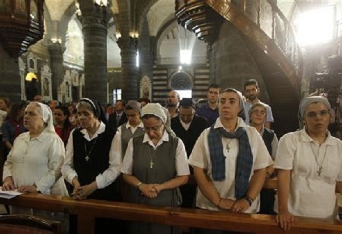 Nuns pray during mass in the Catholic Patriarchate in Damascus, September 7, 2013.