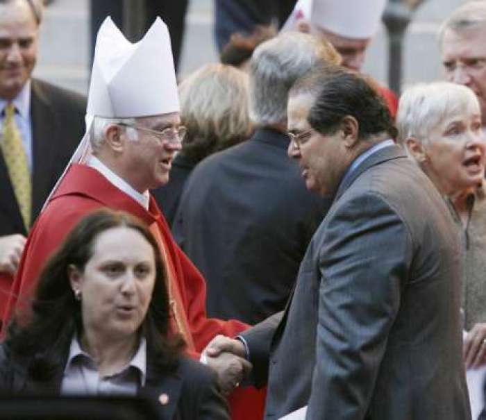 U.S. Associate Justice Antonin Scalia (R) shakes hands with an unidentified Bishop following the Red Mass at the Cathedral of Saint Matthew the Apostle in Washington, September 30, 2007. Several Supreme Court Justices attended Red Mass, celebrated annually in the Catholic Church for judges, prosecutors, attorneys, law school professors and students, and government officials.