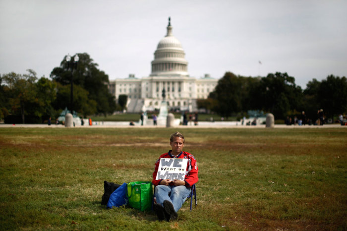 Credit : Furloughed Americorps employee Jeffrey Wismer sits alone on the Washington Mall October 8, 2013, as he calls on congress to end the government shut down. Republicans offered a new approach on Tuesday to resolve the U.S. fiscal standoff, proposing creation