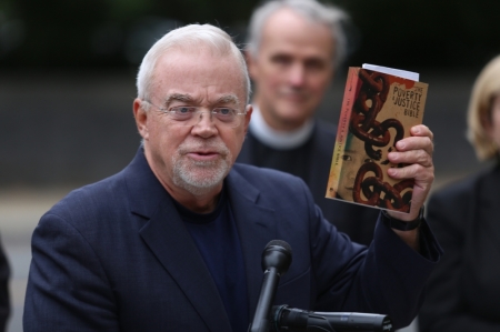 Jim Wallis, president of Sojourners, holding up a "Poverty and Justice Bible" at the "Faithful Filibuster" protest, Washington, D.C., Oct. 10, 2013.