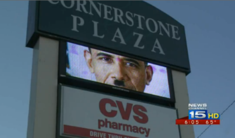 A video billboard ad at a Kendallville, Ind., shopping center portrays President Barack Obama with an Adolf Hitler mustache and the message 'impeach Obama.' The ad was removed on Oct. 15, 2013.