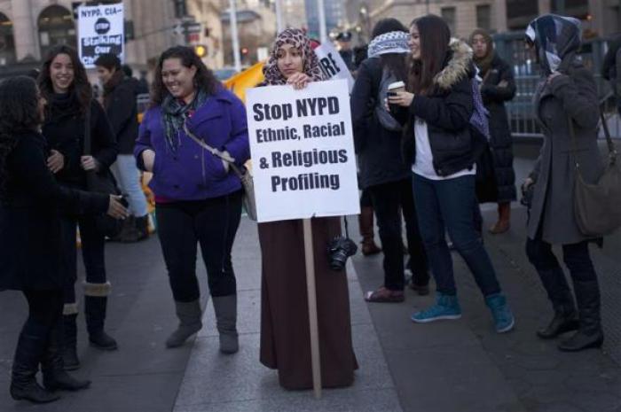 A woman holds a sign protesting against New York police attitudes toward Muslims in New York November 18, 2011.