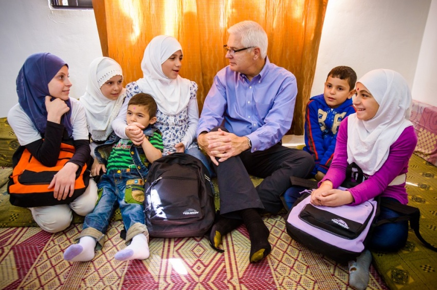 Syrian refugee children living in Jordan share their hopes and dreams with Rich Stearns. World Vision distributed school backpacks, filled with school supplies, during Rich's visit to a World Vision-funded remedial school, where hundreds of Syrian and Jordanian children are benefiting in lessons in English, Arabic and math. The children are among the beneficiaries. Haya, seated left, tells Rich her favorite item in the backpack: A blanket. 
