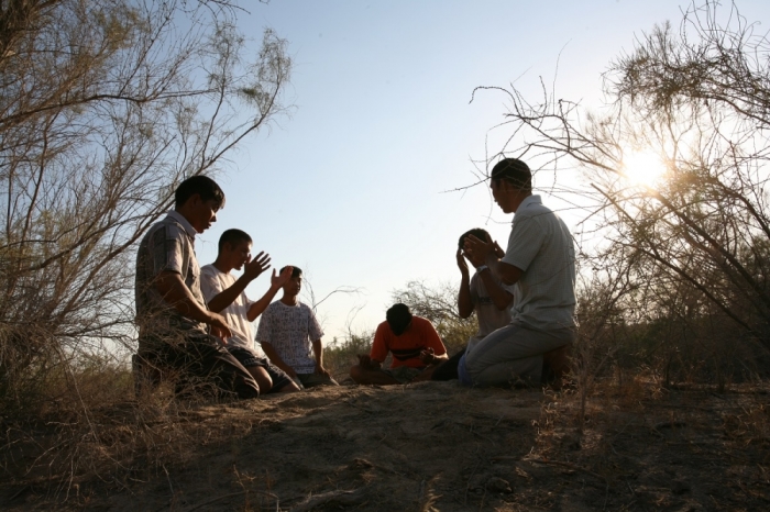 Uzbek believers holding a prayer meeting in secret in the desert, July 2008.