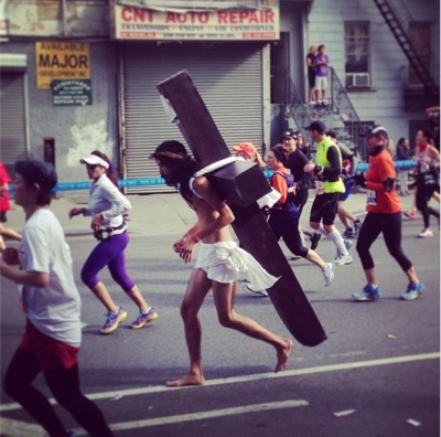 A man seemingly dressed as Jesus, with a large cross strapped to his back, ran in the New York City Marathon on November 3.