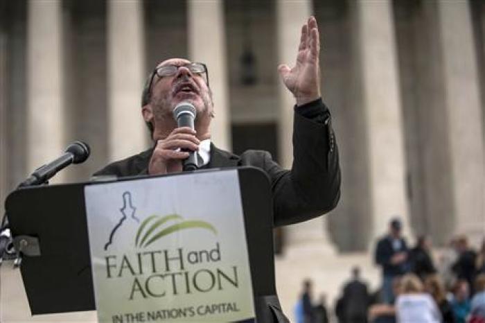 Rev. Patrick Mahoney of the Christian Defense Coalition prays outside the U.S. Supreme Court as it hears arguments in the case of Town of Greece, NY v. Galloway, in Washington November 6, 2013.