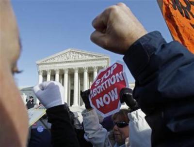 Anti-abortion protestors take part in a demonstration marking the anniversary of the U.S. Supreme Court's 1973 Roe v. Wade abortion decision in front of the Supreme Court building (rear) in Washington, Jan. 24, 2011.