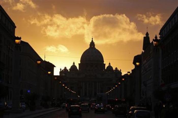 Saint Peter's Basilica at the Vatican is silhouetted during sunset in Rome, March 11, 2013.
