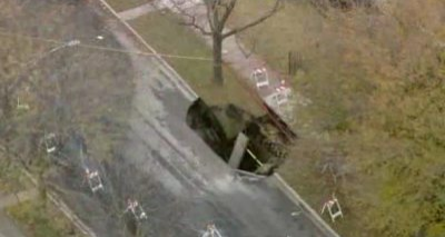 A large sinkhole has opened up and swallowed part of the road in Chicago's West Pullman neighborhood.