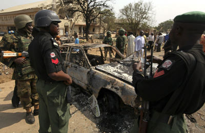 Security forces view the scene of a bomb explosion at St. Theresa Catholic Church at Madalla, Suleja, just outside Nigeria's capital Abuja, on Dec. 25, 2011. Jihadist group Boko Haram claimed responsibility.