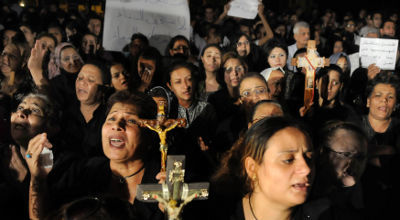 Egyptian Coptic Christians carry crosses and chant prayers at Abassaiya Cathedral in Cairo, (FILE)