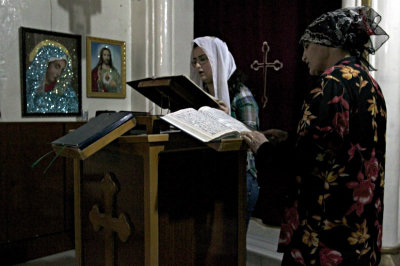 Worshippers attend a mass at the Syriac Orthodox Church in Al-Darbasiyah, Hasakah province on Nov. 13, 2013. Due to the clashes in north-eastern Syria, many Christians have fled the area seeking safety elsewhere, activists say.