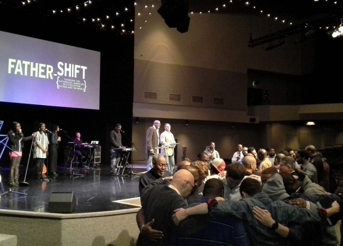 Speakers Dr. Mark Strong and Dr. Ken Canfield help to facilitate prayer during the Father-Shift conference at City Church in Kirkland, Wash., Nov. 16, 2013.