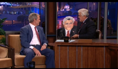 George W. Bush presenting Jay Leno with a portrait on the Tonight Show on Nov. 19, 2013.