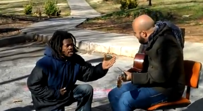 Homeless man interrupts music video to worship.