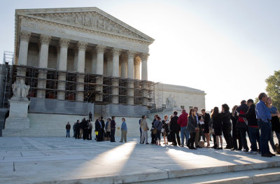 People line up to hear oral arguments, including the case Schuette v. Coalition to Defend Affirmative Action, at the Supreme Court in Washington October 15, 2013. The U.S. Supreme Court will delve into a decades-old debate over university admissions policies that favor racial minorities, hearing a Michigan case that picks up where the justices left off last session in a dispute from the University of Texas.