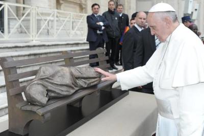 Pope Francis prayer over and touches 'Jesus the Homeless' sculpture created by Canadian artist Tim Schmalz at St. Peter's Square in Vatican City, Rome, Italy, on Nov. 20, 2013.