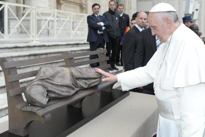 Pope Francis says a prayer over and touches 'Jesus the Homeless' sculpture created by Canadian artist Tim Schmalz at St. Peter's Square in Vatican City, Rome, Italy, on Nov. 20, 2013.