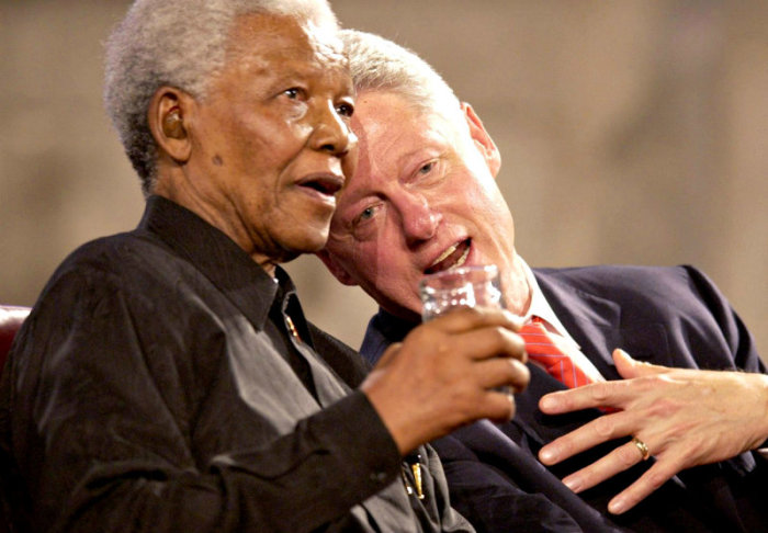 Former U.S President Bill Clinton (R) and former South African President Nelson Mandela (L) speak during a Gala night in Westminster Hall, London, July 2, 2003.