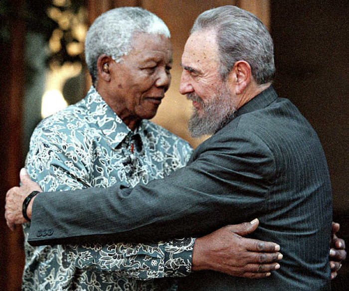 Former South African President Nelson Mandela (L) hugs Cuba's President Fidel Castro during a visit to Mandela's home in Houghton, Johannesburg in this Sept. 2, 2001, file photo.