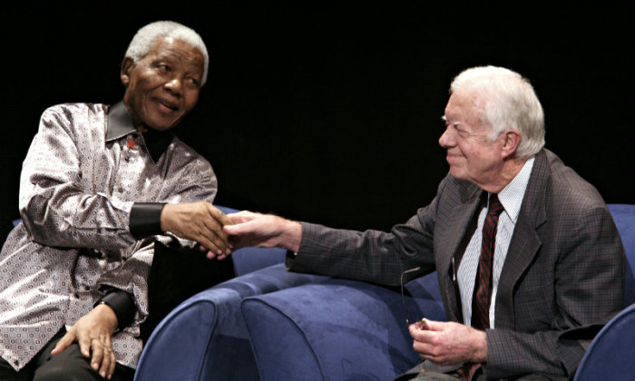Former President of South Africa, Nelson Mandela (L) shakes hands with the former U.S. President, Jimmy Carter during a ceremony marking his 89th birthday in Johannesburg, July 18, 2007.