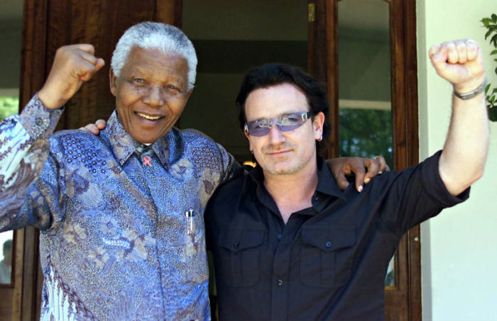 Irish rock star Bono (R) and Former South African President Nelson Mandela pose after they met at Mandela's resident at Houghton in Johannesburg May 25, 2002.