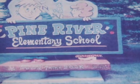 The Pine River Area School Board in Osceola County, Mich., has approved a sign with the United States motto "In God we trust" painted in the corner of a new sign for two merging elementary schools.