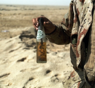 A member of a demolition team from Task Force Alpha, 2nd Marine Division, displays a Molotov cocktail that failed to work during Operation Desert Storm.