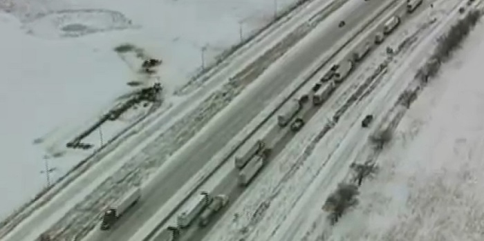 Eighteen-wheelers and cars pile up along Interstate 35 after a ice storm in Texas ground traffic to a halt.
