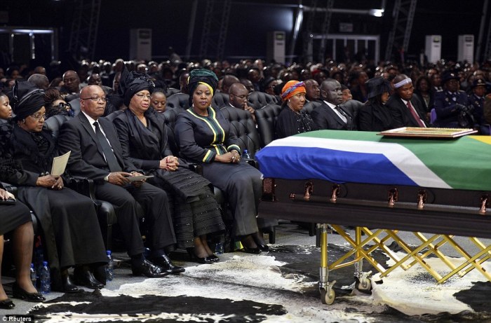 South Africa's president Jacob Zuma (2nd left), Mandela's ex-wife Winnie Mandela (left), and the widow of Mandela, Graca Machel (3rd left), sit by his coffin.