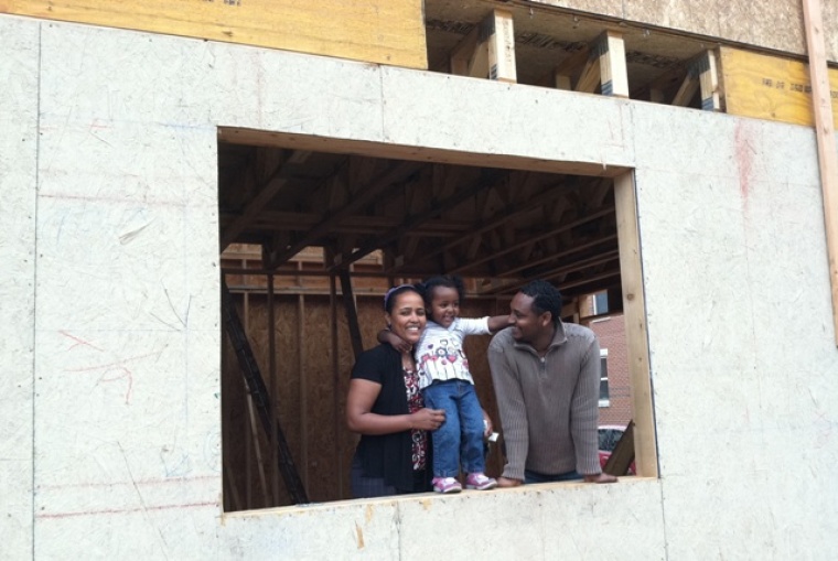 Sintayehu Garoma and his wife, Hailu, and their daughter, Sifin, await the completion of their Habitat house, constructed in part with lumber from the 2011 Rockefeller Center Christmas tree.