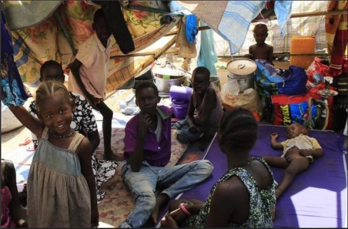 A displaced family from South Sudan's Nuer tribe, who fled their home in fear of ethnic killing by the Dinka-led government, erects a makeshift shelter inside the United Nations Mission in Sudan (UNAMIS) facility in Jabel, on the outskirts of Juba December 23, 2013.