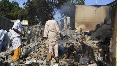 Men walk amid rubble after Boko Haram militants raided the town of Benisheik in northeast Nigeria, on Sept. 19. The Islamist group has been waging an insurgency in northern and central Nigeria for the past four years and was recently placed on the U.S. list of terrorist groups.