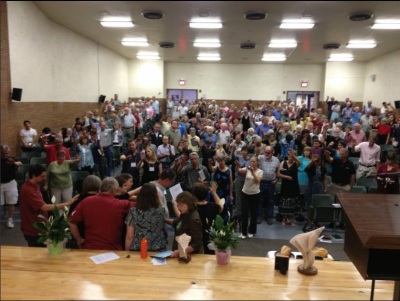 Attendees at the Mountain States Mennonite Conference's Annual Assembly prays for their conference minister in this photo posted on August 4, 2013.