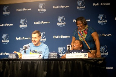 Grizzlies head coach Dave Joerger, 'wish kid' Charvis Brewer and his mom Colissa laugh during the press conference announcing Charvis's draft and contract signing on Sunday, Dec. 29, 2013.