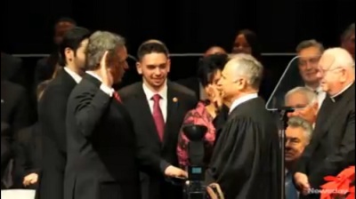 Nassau County Executive Edward Mangano is sworn in for a second term on Jan. 1 with his left hand on an iPad Bible.