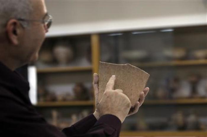 Archaeologist Yosef Garfinkel shows a shard of pottery at the Hebrew University in Jerusalem, October 30, 2008.