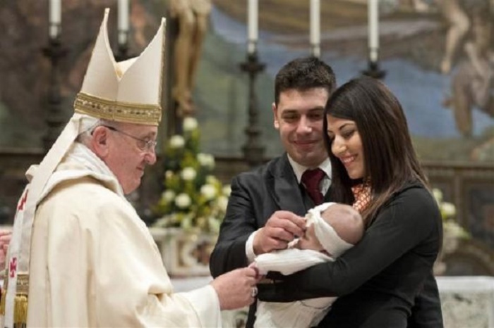 Pope Francis baptises one of 32 babies during a mass in the Sistine Chapel at the Vatican January 12, 2014, in this handout courtesy of Osservatore Romano.