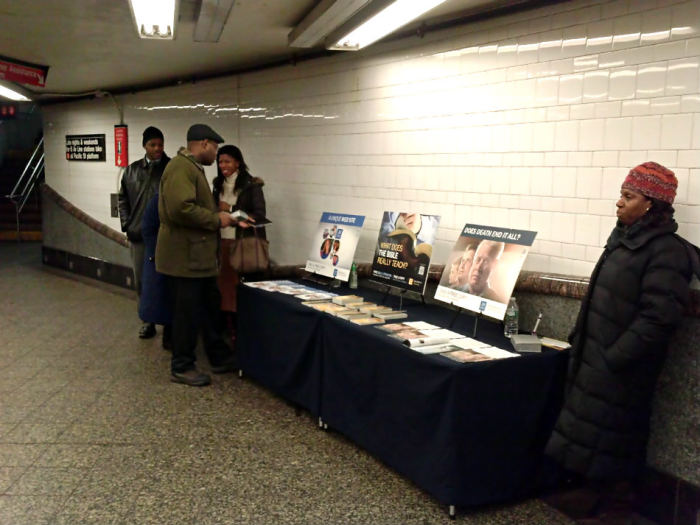 A group of Jehovah's Witnesses stand by their table displaying religious literature on Friday, Jan. 10, 2014, at the Atlantic Terminal subway station in New York City.