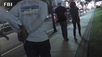 An arrest made by law enforcement officers is captured in this still image taken from video in New Jersey, provided by the FBI July 29, 2013.