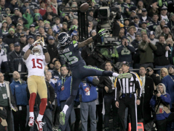 Seattle Seahawks Richard Sherman (C) breaks up a pass to San Francisco 49ers Michael Crabtree (L) that was intercepted by teammate Malcom Smith (R) in the last minute of the fourth quarter in the NFL's NFC Championship game.