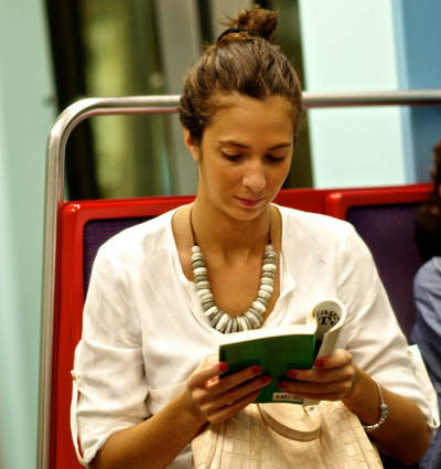 A woman reads a book. (FILE)