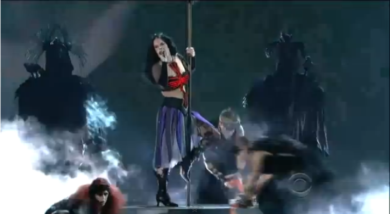 Katy Perry uses an upside-down witch's broom as a pole to pole dance in her 'Satanic' performance of 'Dark Horse' at Sunday's Grammy's.