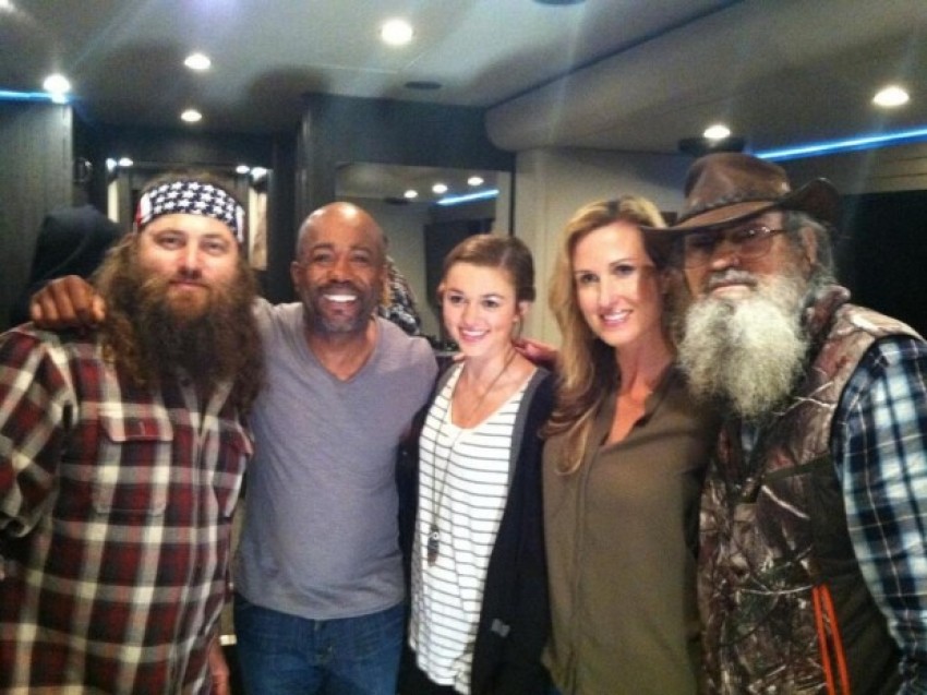 Robertson family members of "Duck Dynasty" pose with singer Darius Rucker after participating in his music video in 2013.