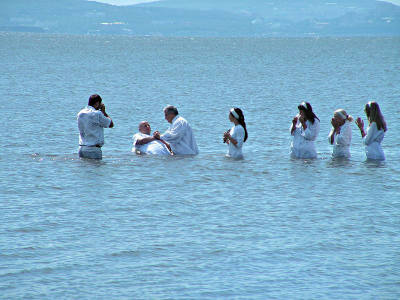 Several people are baptized in this file photo.