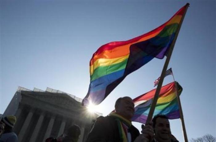 Supporters of gay marriage hold rainbow-colored flags as they rally in front of the Supreme Court in Washington, D.C. on March 27, 2013.