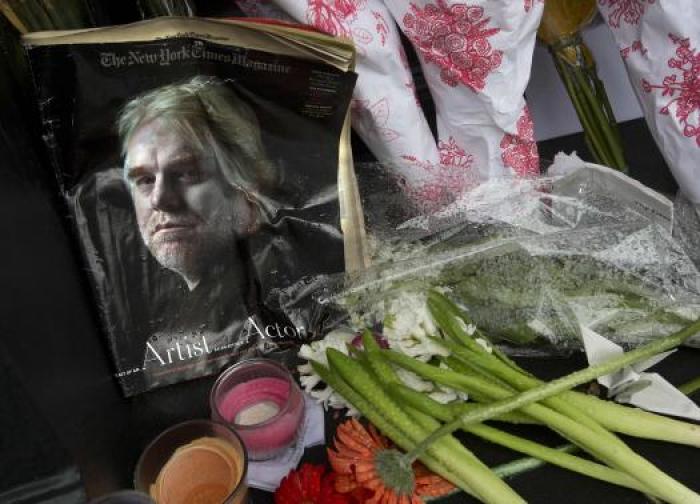 A copy of a New York Times Magazine with a photo of movie actor Philip Seymour Hoffman on the cover is pictured as part of a makeshift memorial in front of his apartment building in New York February 3, 2014.