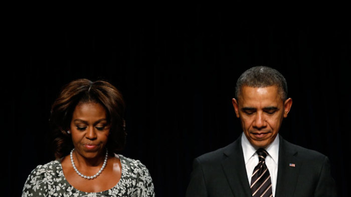 U.S. President Barack Obama and First Lady Michelle Obama bow their heads in prayer while attending the National Prayer Breakfast in Washington February 6, 2014.